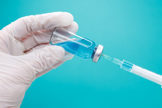 medico-che-prepara-un-iniezione-le-mani-in-guanti-tengono-la-siringa-per-iniezione-e-la-fiala-di-medicina_210733-101