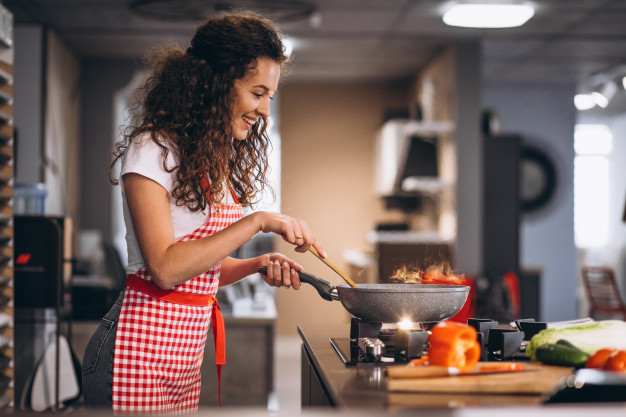 woman-chef-cooking-vegetables-pan_1303-22287