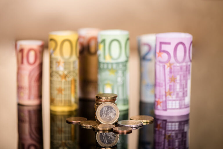 rolls of euro bank notes paper bills money and coins