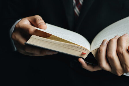 close-up-man-reading-book-shows-close-up-hand-book_38391-678