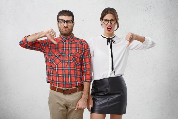 discontent-woman-man-keep-thumbs-down-disapprove-something-frown-faces_273609-8335
