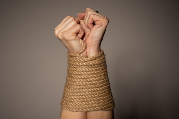 woman-s-hands-tied-with-rope_132310-4914