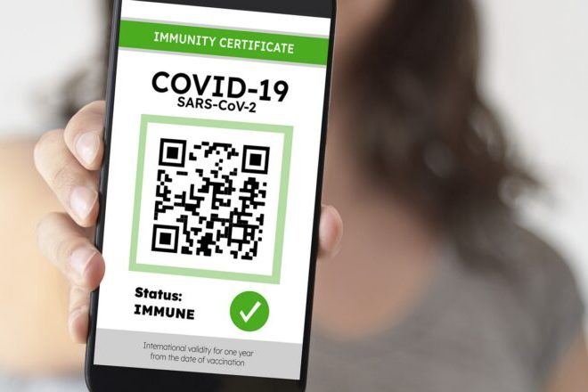 Unrecognizable woman showing on her smartphone a certificate of Covid immunity