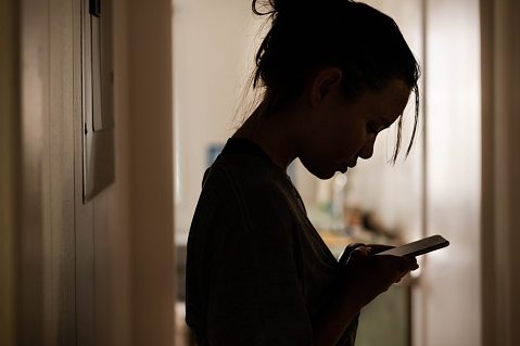 Silhouette of a gloomy girl getting a serious message