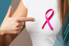 woman in t-shirt with pink cancer ribbon pointing