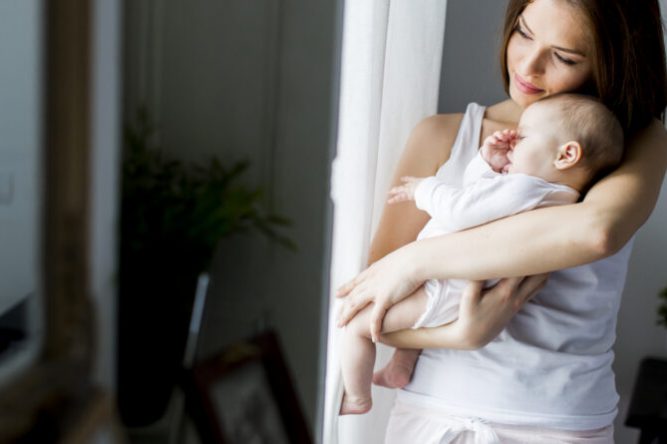 Happy mother with newborn baby girl