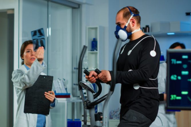 Medical doctors in sports science lab measuring performance cardiorespiratory