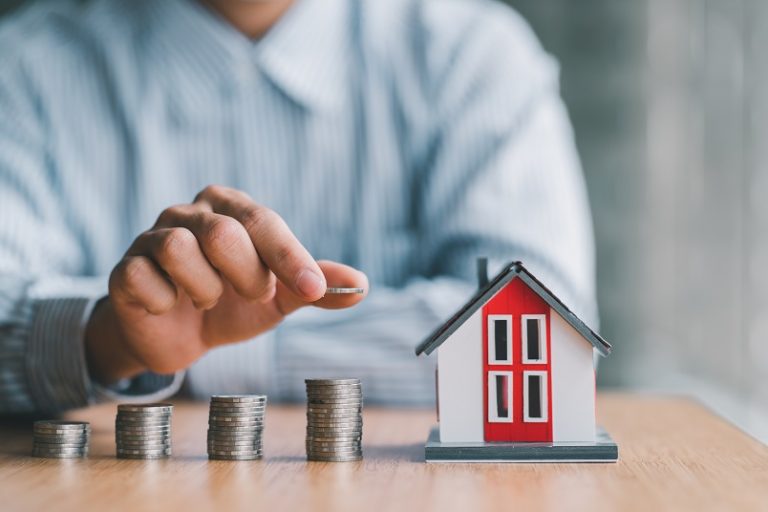 stack of money and home models, home insurance ideas and insuran