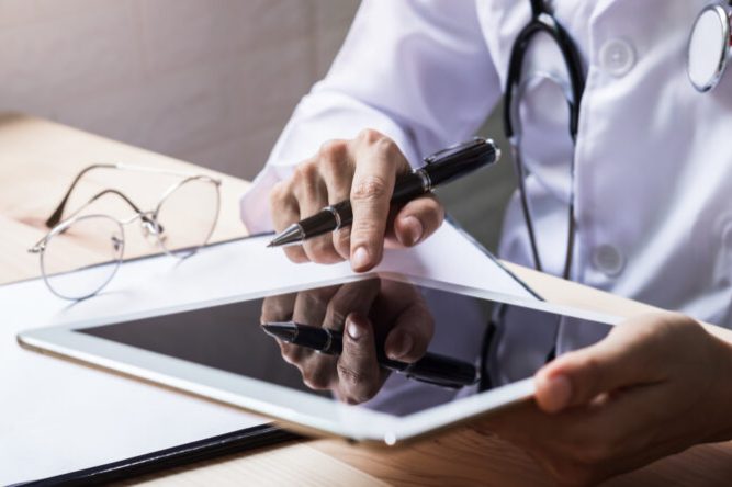 Doctor using a digital tablet in the hospital, Healthcare and Medicine concept.
